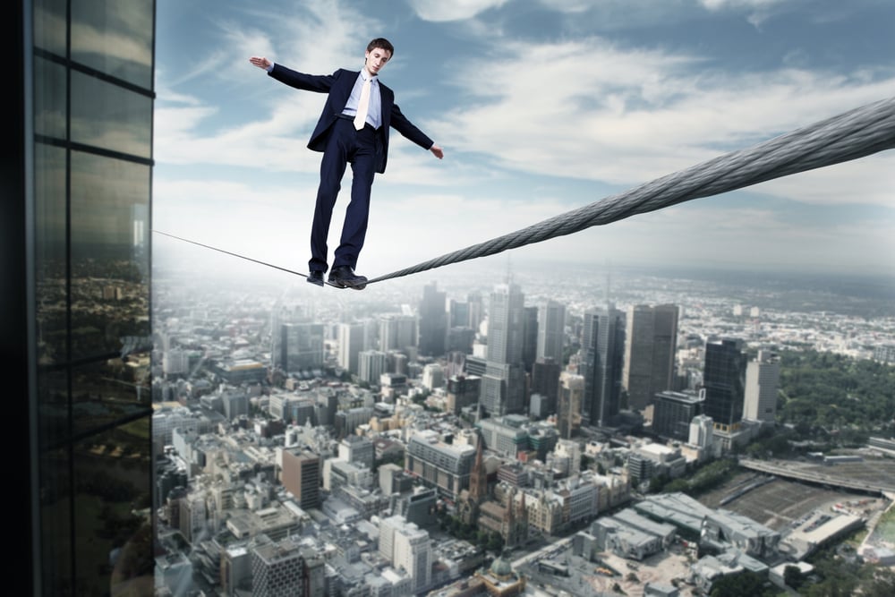 Business man balancing on the rope high in the sky-1